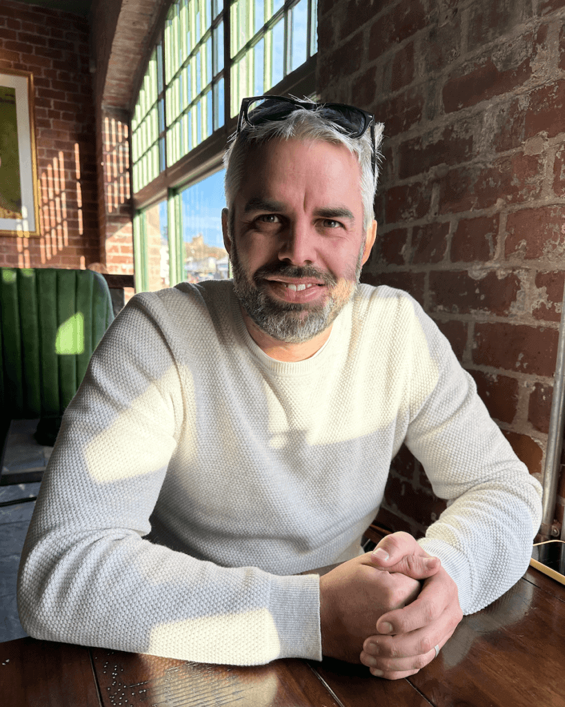 Image of alex robson at a table